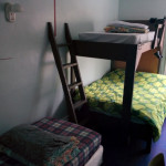 Room 3 with double bed over single bed and another single bed in The Arlington aka HI South Algonquin Backpackers Hostel in Maynooth Ontario