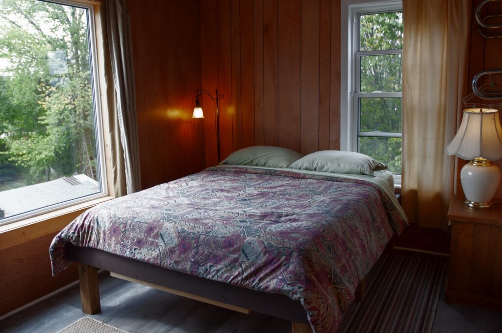 queen bed, large window, small window, two lamps