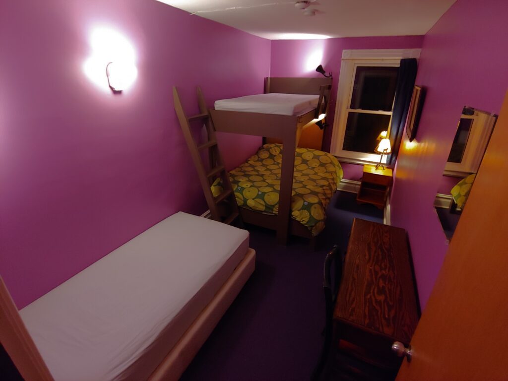 purple room single bed, bunk bed, desk, night table
