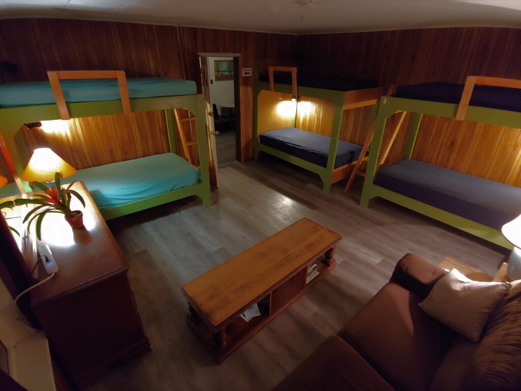 three bunk beds, couch, coffee table, dresser