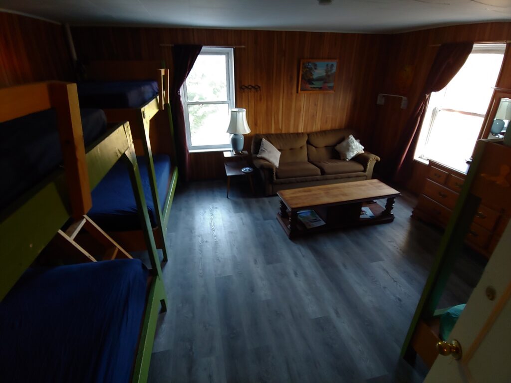 three bunk beds, couch, coffee table, dresser