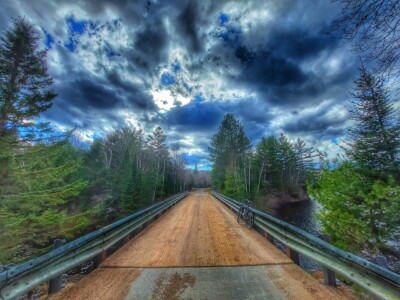wooden bridge over Mink Lake with bicycle leaning on railing