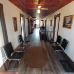 Third Floor Hallway hallway with chairs and red tin ceiling
