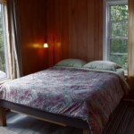 queen bed, large window, small window, two lamps